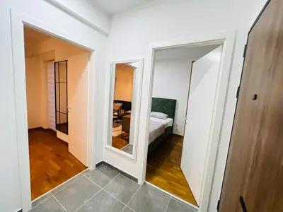 a room with a bed and a mirror at Apartment Gina-Centar in Banja Luka