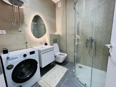 a bathroom with a washing machine and a toilet at Apartment Gina-Centar in Banja Luka