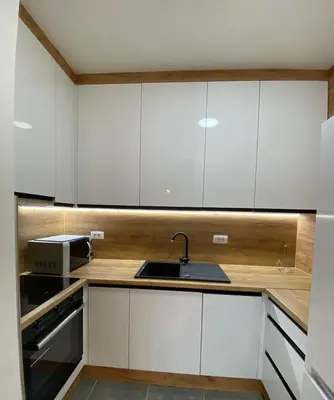 a kitchen with white cabinets and a sink and a microwave at Apartment Gina-Centar in Banja Luka