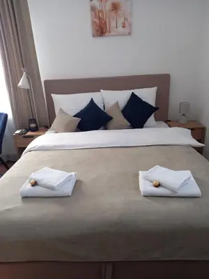 a large bed with two white towels on it at Apartman Mijate in Banja Luka