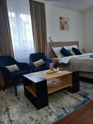 a hotel room with a bed and a coffee table at Apartman Mijate in Banja Luka