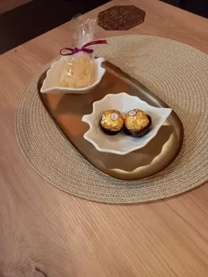 a plate with two muffins on a table at Apartman Mijate in Banja Luka