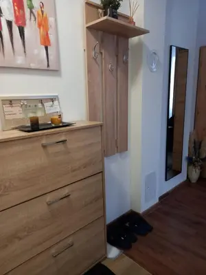 a chest of draws in a room with a mirror at Apartman Mijate in Banja Luka