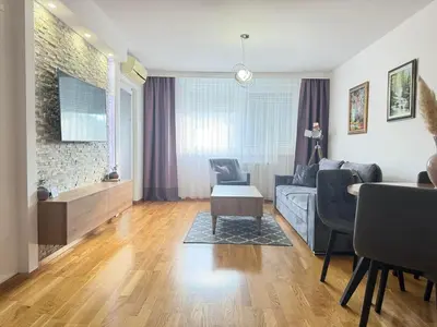 a living room with a couch and a table at Apartman SLEEP&JOY Tuzla in Tuzla
