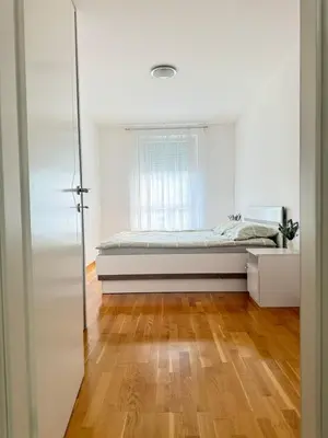 a bedroom with a bed and a window at Apartman SLEEP&JOY Tuzla in Tuzla