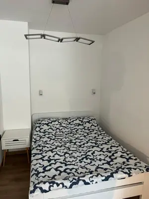a bedroom with a bed with a black and white comforter at Apartman Alan in Travnik