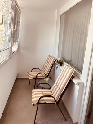 two chairs in a room with a window at Apartman Alan in Travnik