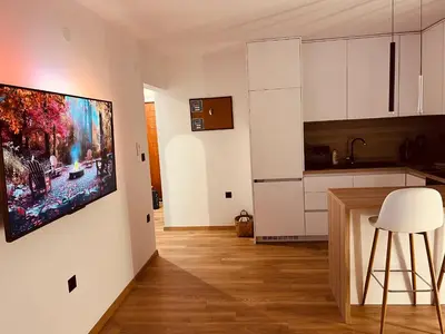 a kitchen with a large painting hanging on a wall at Apartman Alan in Travnik