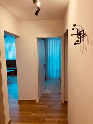 a hallway with a door and a ceiling fan at Apartman Alan in Travnik