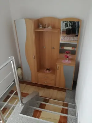 a room with a wooden cabinet and a staircase at Apartman Halida in Visoko