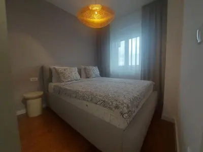 a bedroom with a bed and a chandelier at BL Lux in Banja Luka
