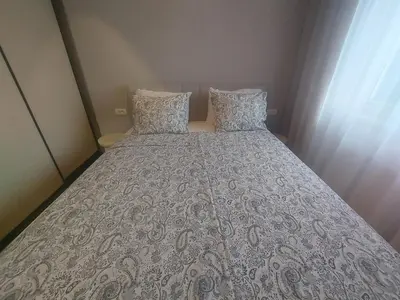 a large bed in a small room with a bedspread at BL Lux in Banja Luka