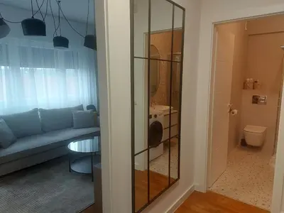 a living room with a couch and a glass door at BL Lux in Banja Luka