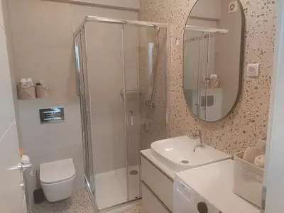 a bathroom with a shower and a toilet and a sink at BL Lux in Banja Luka