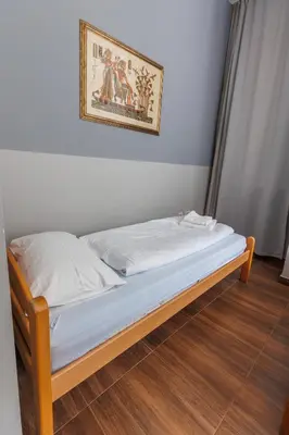 a bed in a room with a picture on the wall at Motel Kobilj in Banja Luka