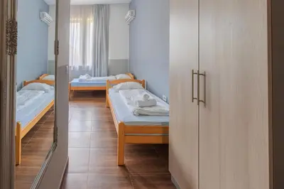 a room with two beds and a closet at Motel Kobilj in Banja Luka