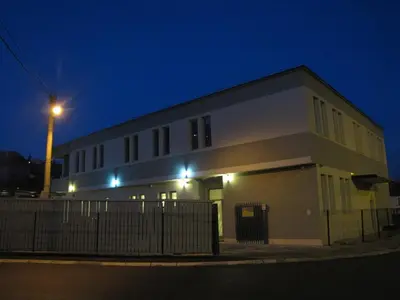 a large white building with a street light at night at Motel Kobilj in Banja Luka