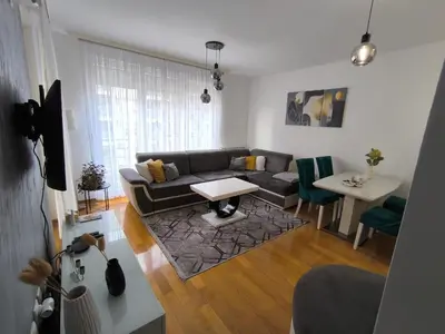 a living room with a couch and a table at Apartman 19-Centar in Banja Luka