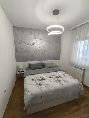 a bedroom with a large bed in a room at Apartman 19-Centar in Banja Luka