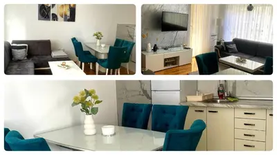 a kitchen and a living room with blue chairs and a table at Apartman 19-Centar in Banja Luka