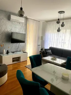 a living room with a couch and a table at Apartman 19-Centar in Banja Luka