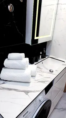 a bathroom with a sink and a washing machine at Apartman 19-Centar in Banja Luka