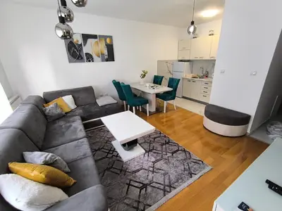 a living room with a couch and a table at Apartman 19-Centar in Banja Luka