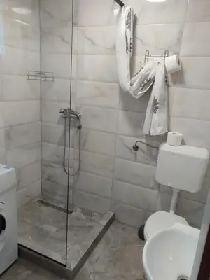 a bathroom with a shower with a toilet and a sink at Apartman Miloš in Bosanska Dubica