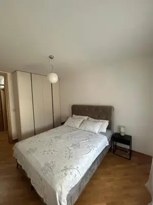 a bedroom with a bed and a night stand at Vert Lux in Banja Luka