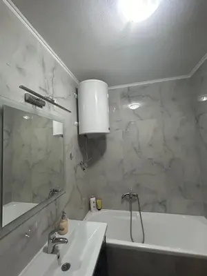 a bathroom with a sink and a tub and a mirror at Vert Lux in Banja Luka