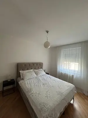a white bedroom with a bed and a window at Vert Lux in Banja Luka