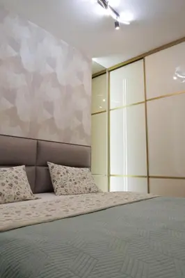 a bedroom with a large bed with two pillows at Palata Gold Apartment in Banja Luka