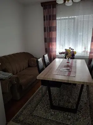 a living room with a table and a couch at Jasmir in Bihać