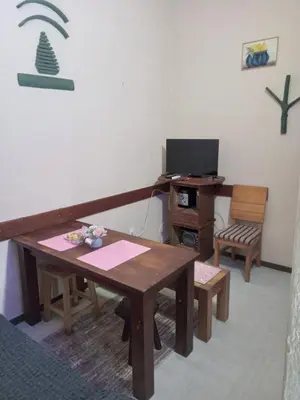 a room with a table and a desk with a computer at Apartman Retro in Žepče