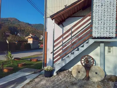 a building with an american flag on the side at Apartman Retro in Žepče