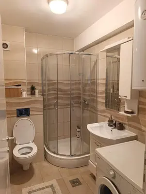 a bathroom with a shower and a toilet and a sink at Apartman Dunja in Banja Luka
