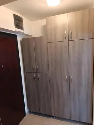 a row of wooden cabinets in a room at Apartman Dunja in Banja Luka