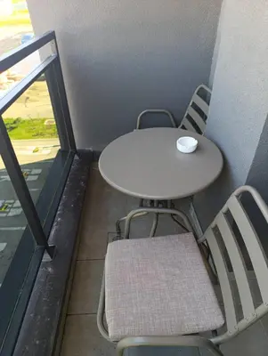 a table and chairs in a room with a table and a table and chairs at Apartman Dunja in Banja Luka