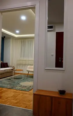 a living room with a mirror and a couch at Ellie in Banja Luka