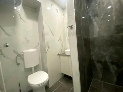 a small bathroom with a toilet and a shower at Ellie in Banja Luka