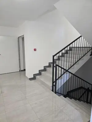 a staircase in a white building with a stair case at A LUX APARTMAN Banja Luka in Banja Luka