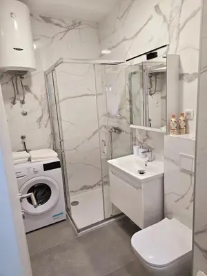 a bathroom with a shower and a toilet and a sink at A LUX APARTMAN Banja Luka in Banja Luka