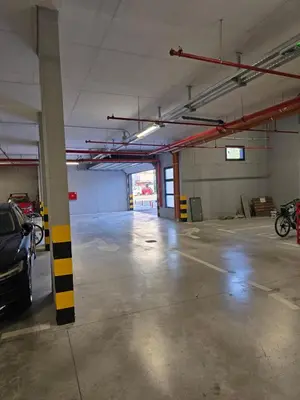an empty parking garage with a car parked in it at A LUX APARTMAN Banja Luka in Banja Luka
