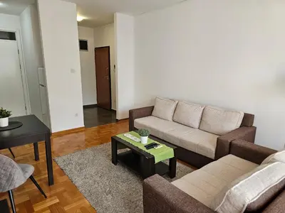 a living room with a couch and a table at Stan Svetozara Markovića 5A in Banja Luka