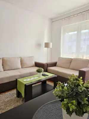 a living room with a couch and a coffee table at Stan Svetozara Markovića 5A in Banja Luka