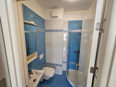 a blue and white bathroom with a toilet and a sink at Stan Svetozara Markovića 5A in Banja Luka