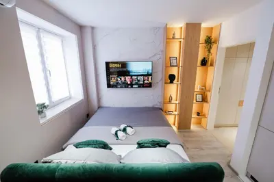 a bedroom with a bed with two stuffed animals on it at Studio Compact in Doboj