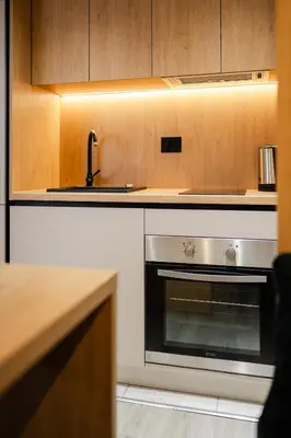 a kitchen with a stainless steel oven and a sink at Studio Compact in Doboj