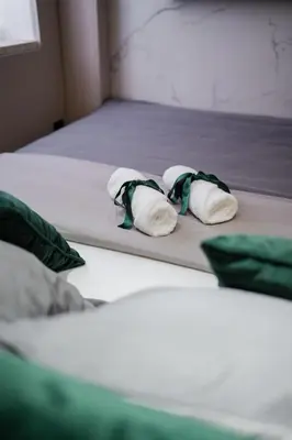 three pillows on a bed in a room at Studio Compact in Doboj