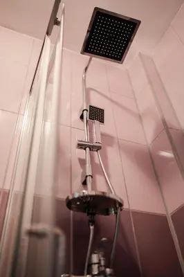 a shower in a bathroom with a ceiling vent at Studio Compact in Doboj
